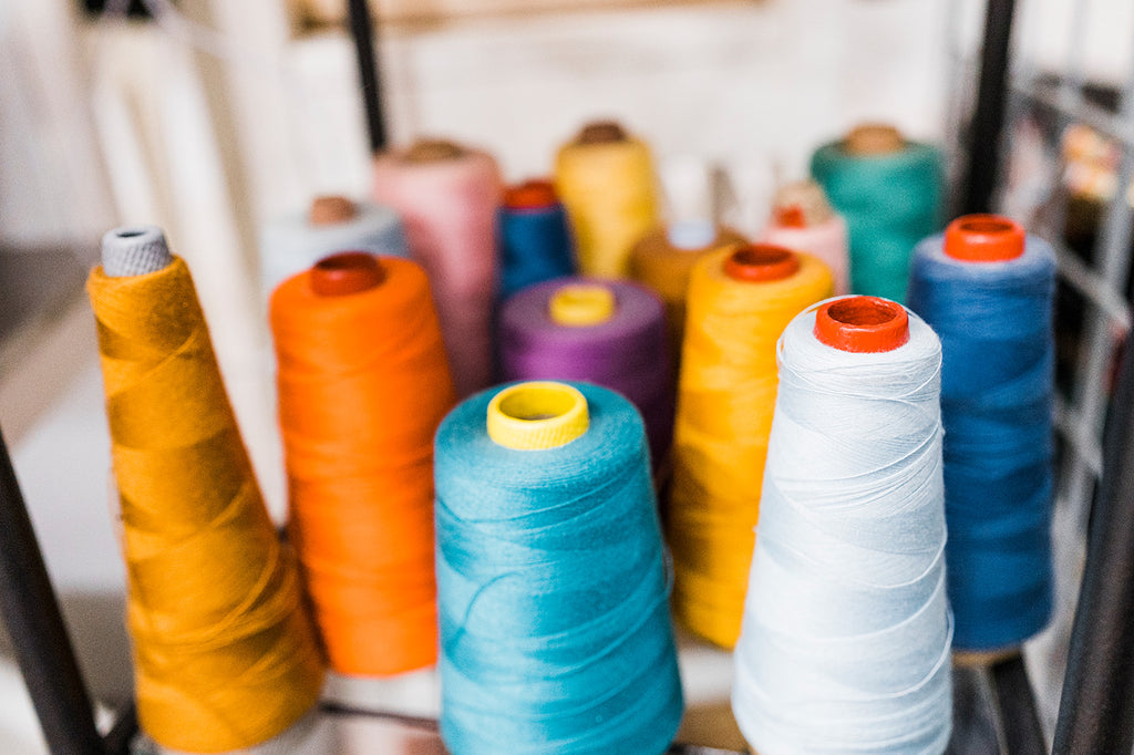 A close up image of colourful spools of thread
