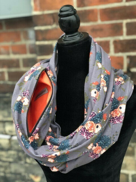 Hidden pocket infinity scarf with florals on a grey background