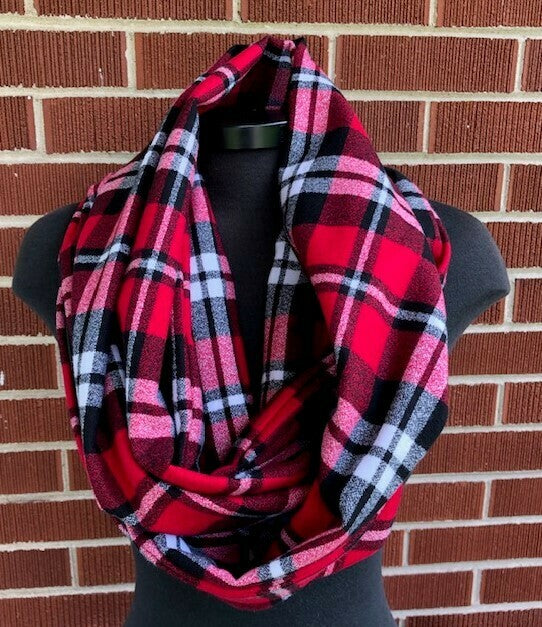Hidden pocket infinity scarf with a red, black and white plaid pattern