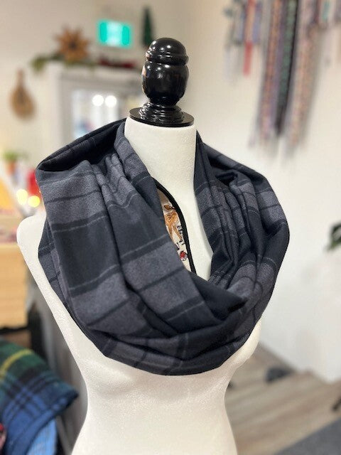 Hidden pocket infinity scarf with a black and grey plaid pattern