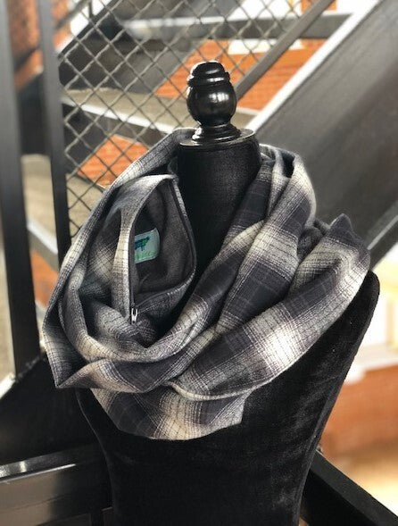Hidden pocket infinity scarf with a dark grey, black and cream plaid pattern