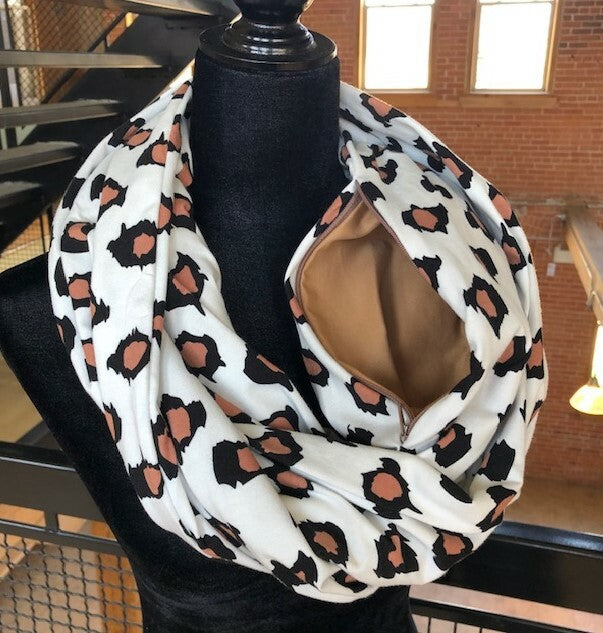 Hidden pocket infinity scarf with a brown animal print pattern