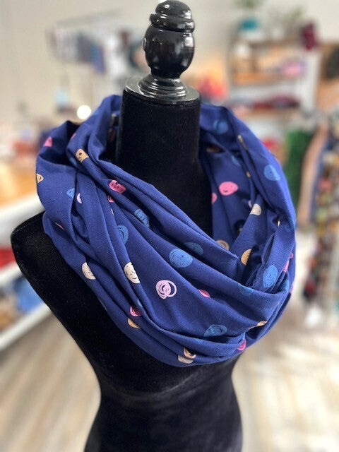 Hidden pocket infinity scarf with a navy blue and dot pattern