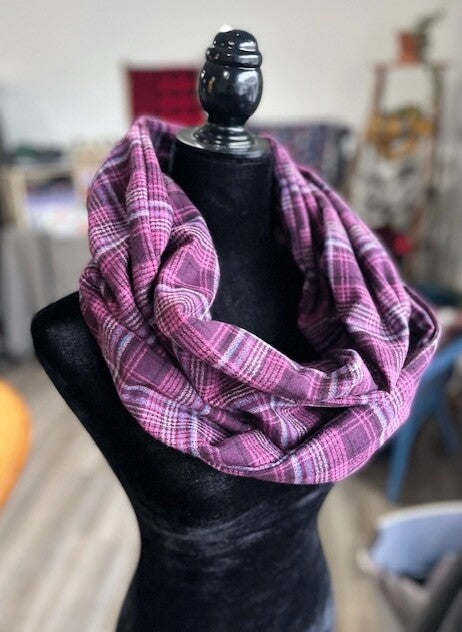 Hidden pocket infinity scarf with a raspberry pink plaid pattern