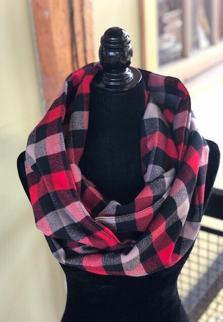 Hidden pocket infinity scarf with a red, grey and black plaid pattern