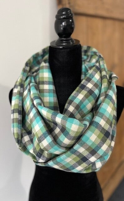 Hidden pocket infinity scarf with a green and dark grey plaid pattern