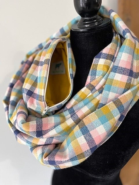 Hidden pocket infinity scarf with a pastel plaid pattern