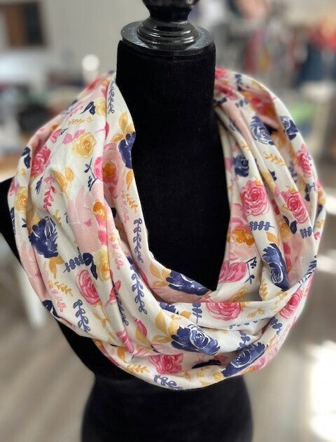 Hidden pocket infinity scarf with yellow, blue and pink florals on a cream coloured background