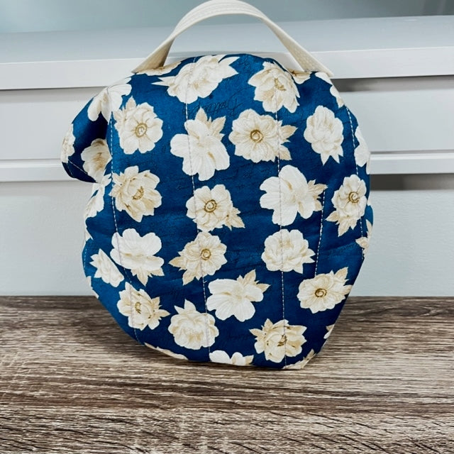 Cream florals on a navy blue cinch sac with cream handle